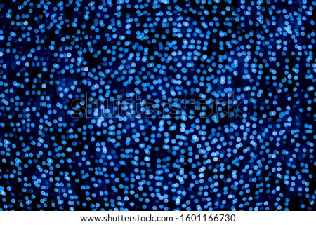 Blurred abstract blue background with bokeh, defocused christmas lights. Holiday christmas concept. Trendy color of the year 2020.
