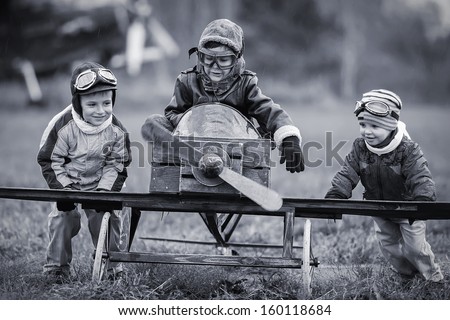 Young aviators at the airport with a homemade airplane Royalty-Free Stock Photo #160118684