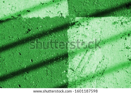 Asphalt surface with white paint and shadow. Abstract background green color toned