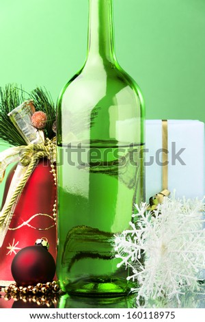 white wine green bottle Christmas gifts and decoration against color background 