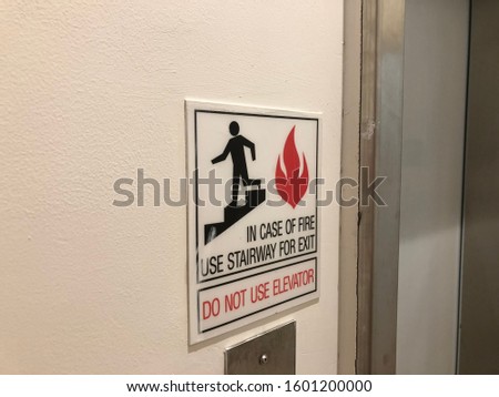 In case of fire use stairway for exit sign —do not use elevator