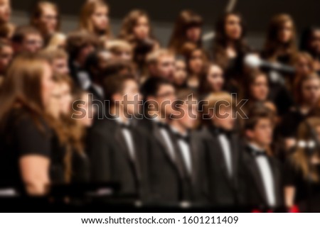 Abstract blur of choir singing while performing during live concert. Royalty-Free Stock Photo #1601211409