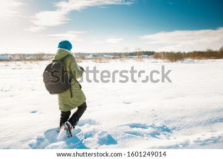 Young Woman Tourist Lady Photograph Taking Pictures Of Snowy Landscape In Sunny Winter Day. Active Lifestyle With Backpack And Camera.