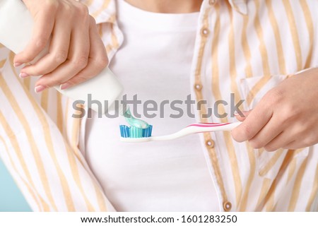 Young woman with toothbrush and paste, closeup