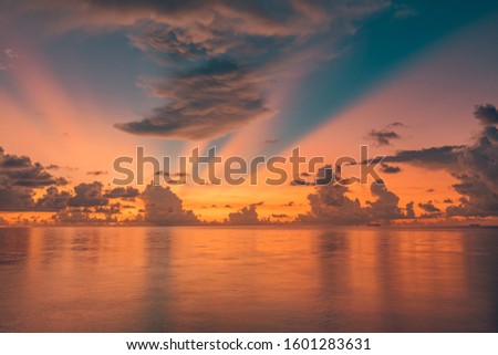 Inspirational calm sea with sunset sky. Meditation ocean and sky background. Colorful horizon over the water. Rays through clouds, peaceful nature reflection, dreamy mood, summer vibes