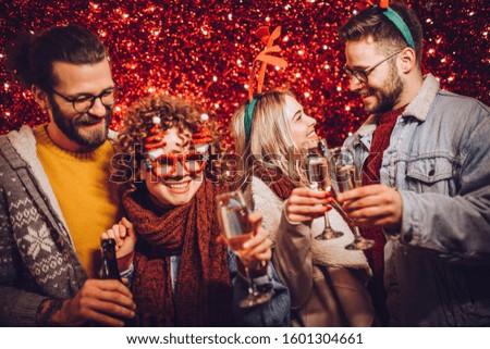 Group of happy friends drinking champagne and celebrating New Year. New year party.