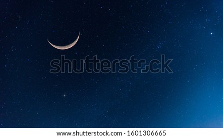 Amazing Crescent Moon on dark blue night sky background.Universe filled with stars, nebula and galaxy with noise and grain.selection focus. Royalty-Free Stock Photo #1601306665
