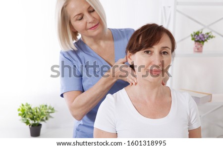 Female patient and doctor have consultation in hospital. Picture of middle aged woman during rehabilitation in professional clinic. Closeup