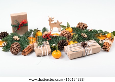 Beautiful, natural, reusable and zero waste composition of christmas objects with craft presents and a wooden deer.