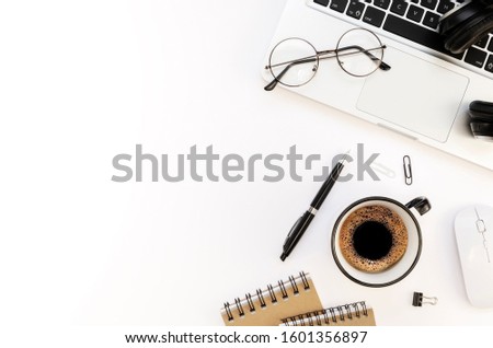 Flat lay programmer's workplace white table with silver laptop and coffee cup. Top view International Programmers' Day concept with pen, spiral notebook and copy space for your text