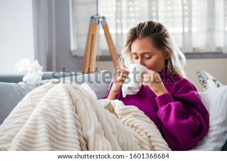 Cold And Flu. Portrait Of Ill Woman Caught Cold, Feeling Sick And Sneezing In Paper Wipe. Closeup Of Beautiful Unhealthy Girl Covered In Blanket Wiping Nose. Healthcare Concept. High Resolution