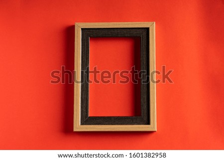 Empty photo frame against red background, copy space for text