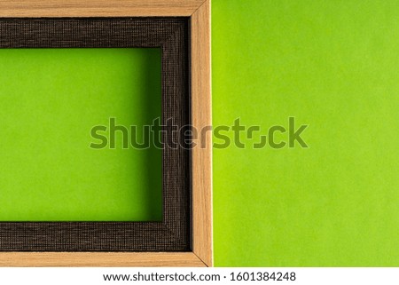Empty photo frame against green background. Copy space for text