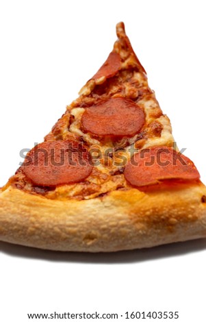 Cut a slice of pizza isolated on a white background. Pepperoni top view.