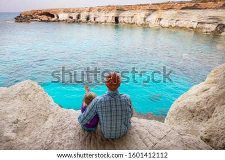Father and little daughter on sea beach