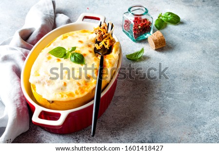 Stuffed spaghetti squash lasagna boats. Healthy seasonal fall or autumn food.  Royalty-Free Stock Photo #1601418427