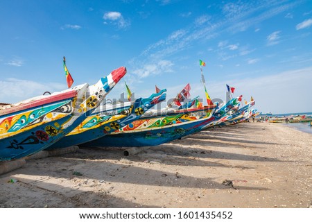 Traditional painted wooden fishing boat in Djiffer, Senegal. West Africa. Royalty-Free Stock Photo #1601435452