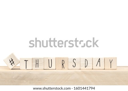 Wooden cubes with hashtag and the word Thursday, social media concept near white background close-up
