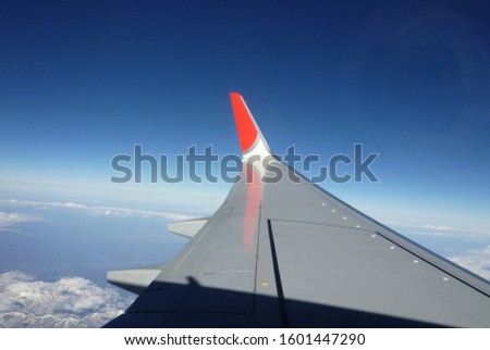 Airplane wing flying above the clouds