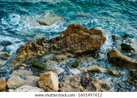Splashes from the waves bumping against the rocky shore, Mediterranean sea, Malaga city, Spain