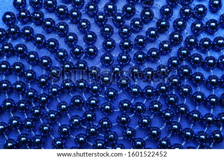 Many blue beads on color background