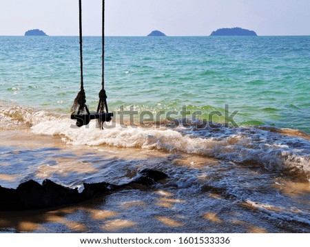 Beautiful white sand beach with blue sea water and blue sky, swing ,sunny day ,summer holiday in Koh Chang Thailand, nature beach background