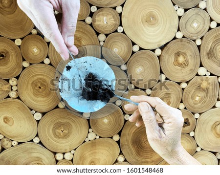 Chocolate cake on a plate on a wooden table With two hands scooping to eat Photos from the top view - stock photo