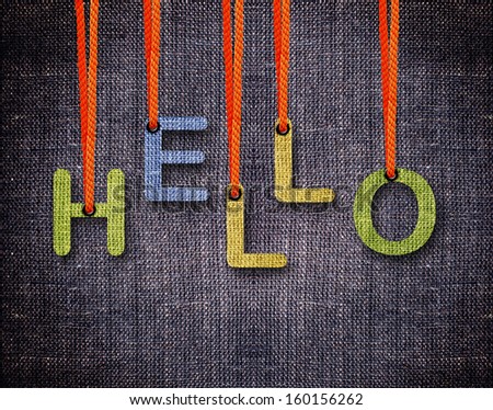 Hello Letters hanging strings with blue sackcloth background.