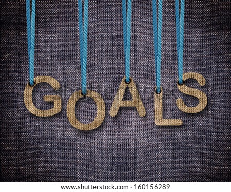 Goals Letters hanging strings with blue sackcloth background.