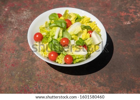 Healthy vegetarian vegan lunch dinner salad bowl  tomato, green vegetable vegetables Top View From Above on a rusty metallic table background