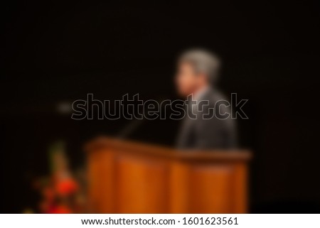 Abstract blur of pastor preaching sermon at church background.  Royalty-Free Stock Photo #1601623561