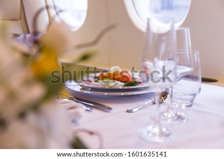 Private jet interior and meal Royalty-Free Stock Photo #1601635141