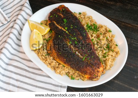 Cajun-style Blackened Red Snapper on Dirty Rice Royalty-Free Stock Photo #1601663029