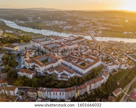 Aerial view of Coimbra with university at top of the hill at sunset, Portugal Royalty-Free Stock Photo #1601666032