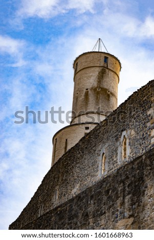 old stone castle on blue sky background