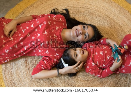 A cute Indian mother and her daughter's pose during a photo shoot