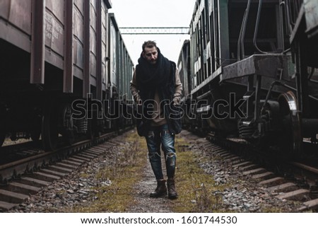 Portrait of a man in the middle of trains.