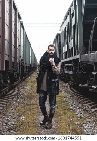 Portrait of a man in the middle of trains.