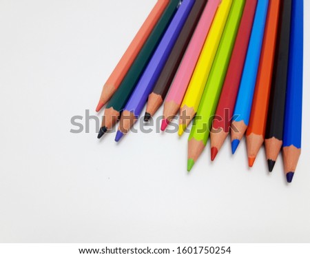 Colored crayons on white background