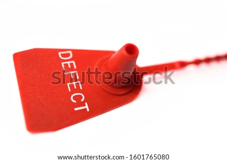 closeup of a red defect marking tag. Warning sign. Attention broken object.
