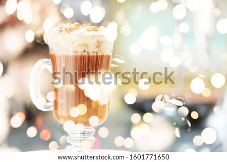 Irish coffee in an outdoor bar. Concept of St Patrick holiday. Holiday background. Irish national day. Warm tone. Horizontal with festive bokeh lights