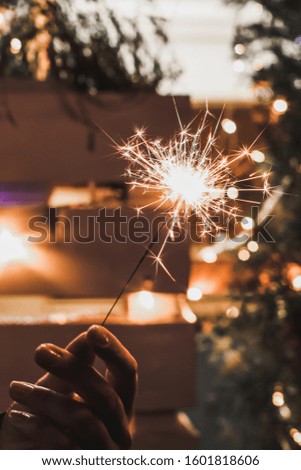 Christmas party. Sparklers in the hand.  holiday in full swing, good mood