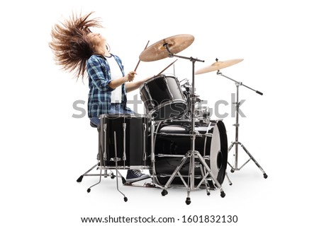 Female drummer playing on a drum set and throwing hair back isolated on white background Royalty-Free Stock Photo #1601832130