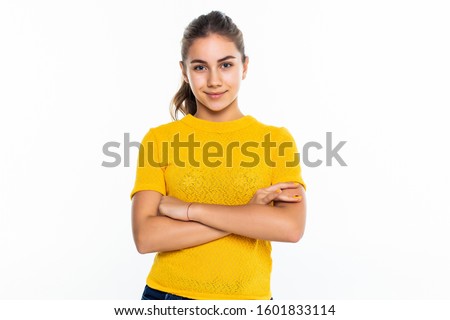 Beautiful Teen Girl Student with confident expression, keeps arms folded. Portrait of Smiling Teenager isolated on white background. Happy child looking at camera.
