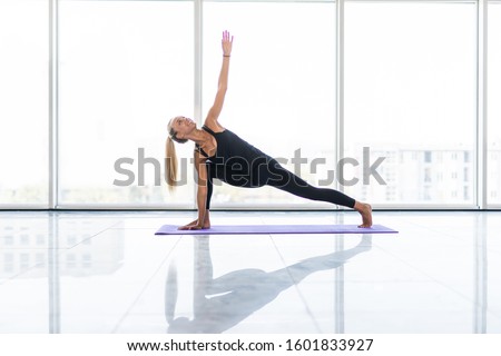 Young beautiful woman practicing yoga with mountain view in the background. Wellness concept. Calmness and relax, woman happiness. Toned picture