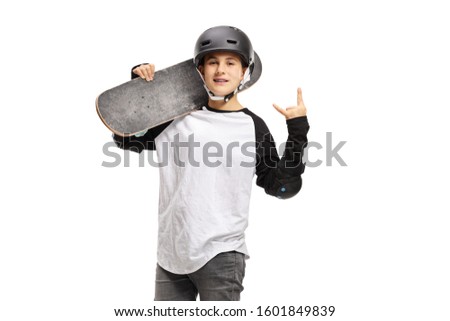 Kid posing with a skateboard and gesturing rock and roll sign isolated on white background