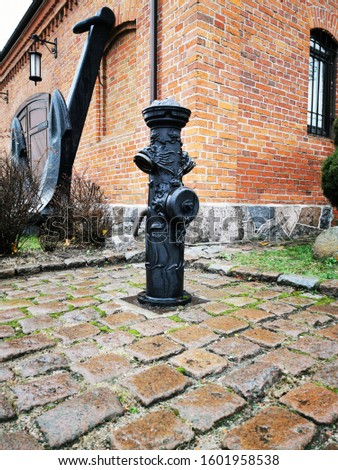 Vintage black fire hydrant. Street style. Industrial safety. Danger prevention. Art vintage.