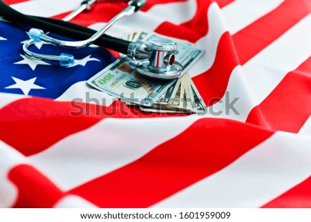 Stethoscope and money on american flag