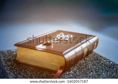 The Holy bible on the black stone floor. Christianity concept. Holy Bible background. 
