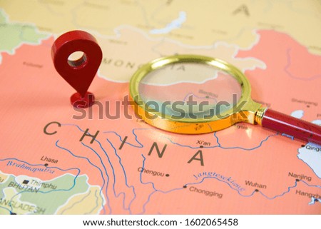 China Map in focus with a GPS location tag icon and a classic magnify glass